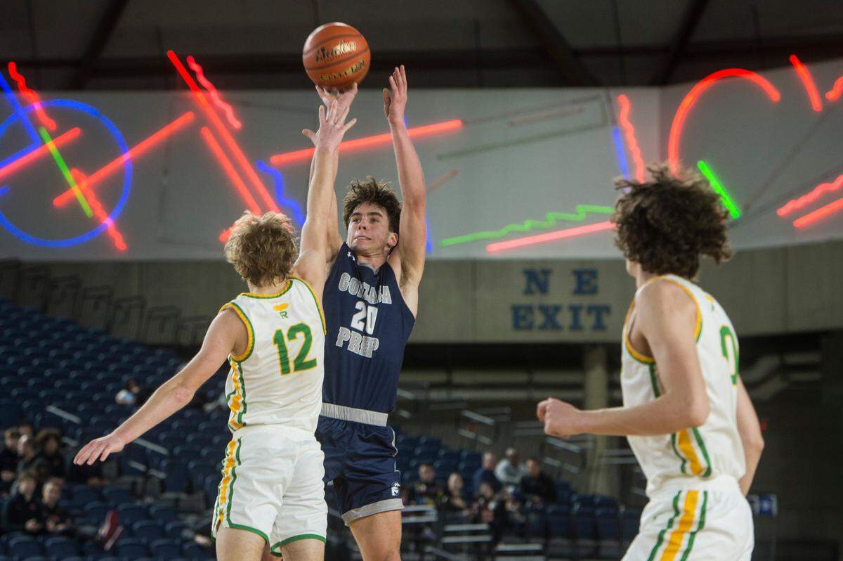 Gonzaga Prep guard Henry Sandberg (20) puts up a shot in the fourth quarter as Richland guard Josh Woodard (12) defends in the consolation round of the Class 4A boys state basketball tournament on Friday, March 3, 2023 at the Tacoma Dome in Tacoma, Wash.