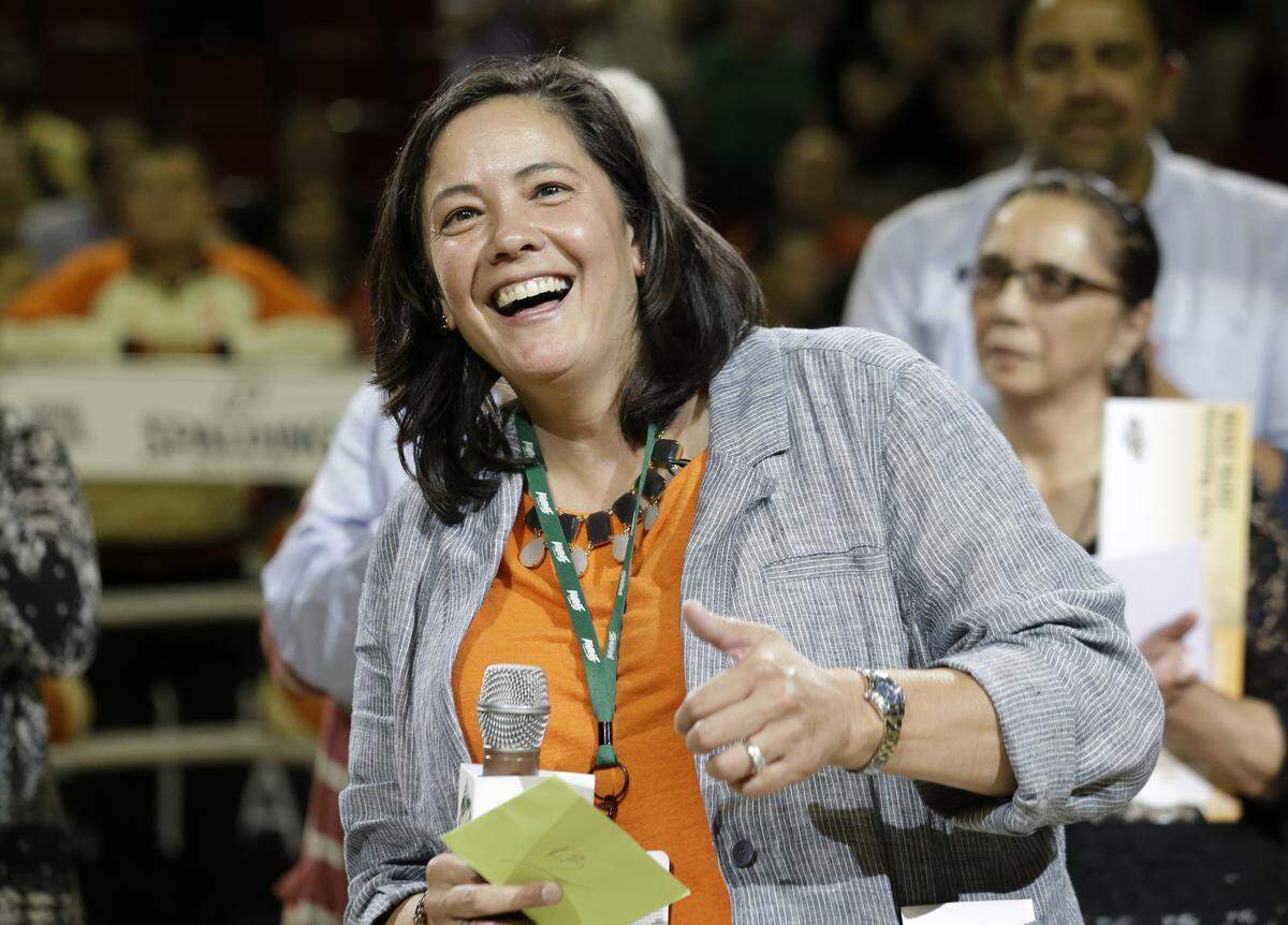 Outgoing Seattle Storm CEO and president Karen Bryant smiles as she is honored on her last day before a WNBA basketball game between the Storm and Indiana Fever Thursday, July 31, 2014, in Seattle.