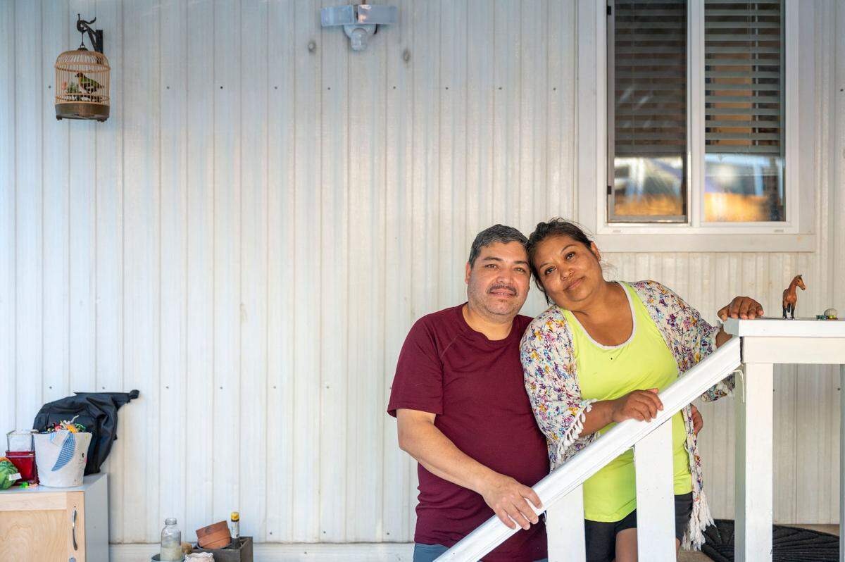 Jorge Calderon and his wife, Saraim Nieto, pose for a portrait on the front porch of their home at Meridian Estates in Puyallup, Wash., on Wednesday, July 27, 2022.