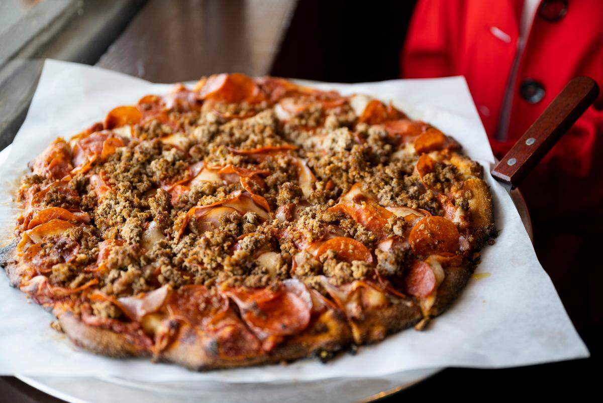 The Formula Four boasts pepperoni, Italian sausage, Canadian bacon and seasoned ground beef. Paul has upgraded the dough and sauce recipes for the better. “We changed it on Day 1,” she said.
