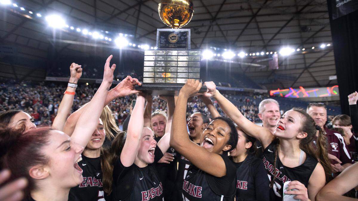 The Eastlake Wolves hoist the state championship trophy as they celebrate their 48-41 win over the Camas Papermakers in the 4A girls state title game at the WIAA state basketball tournament in the Tacoma Dome in Tacoma, Washington, on Saturday, March 4, 2023.