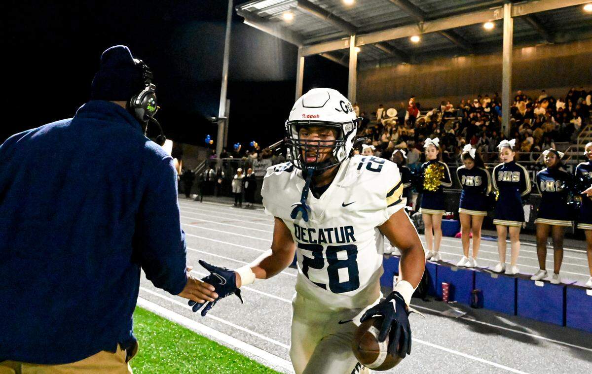 Decatur’s Nehemiah Washington (28) runs back on the field after a play against the Federal Way Eagles during the first half of the game at Federal Way Memorial Stadium, Thursday, Oct. 26, 2023, in Federal Way, Wash.