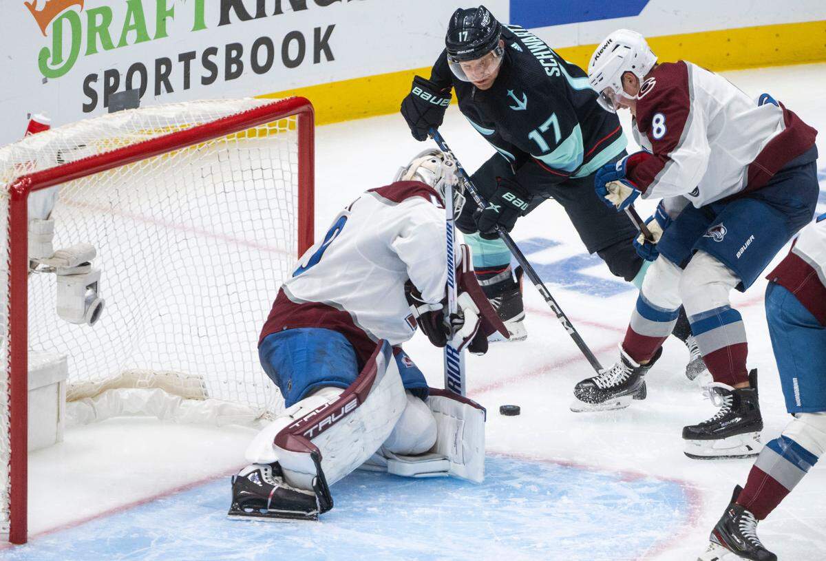Seattle Kraken center Jaden Schwartz (17) tries to shoot the puck as Colorado Avalanche defenseman Cale Makar (8) defends in overtime of a first round 2023 Stanley Cup Playoffs game against the Colorado Avalanches at Climate Pledge Arena in Seattle on Monday, April 24, 2023.