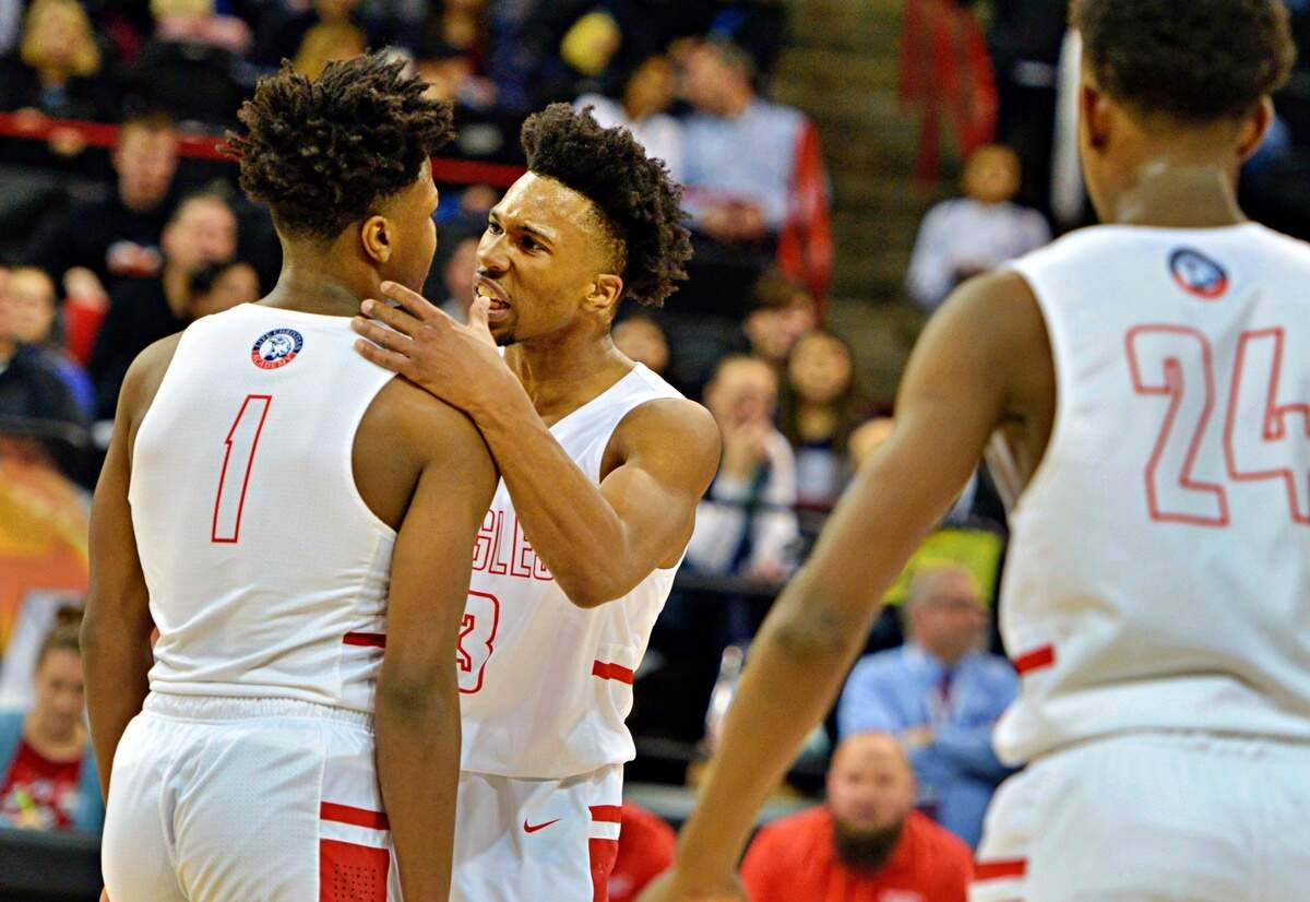Life Christian’s Omari Maulana pumps up Dai’shaun Nichols after Nichols draws a foul in a Class 2B state semifinals game against Saint George’s on Friday, March 1, 2019 in Spokane, Wash.