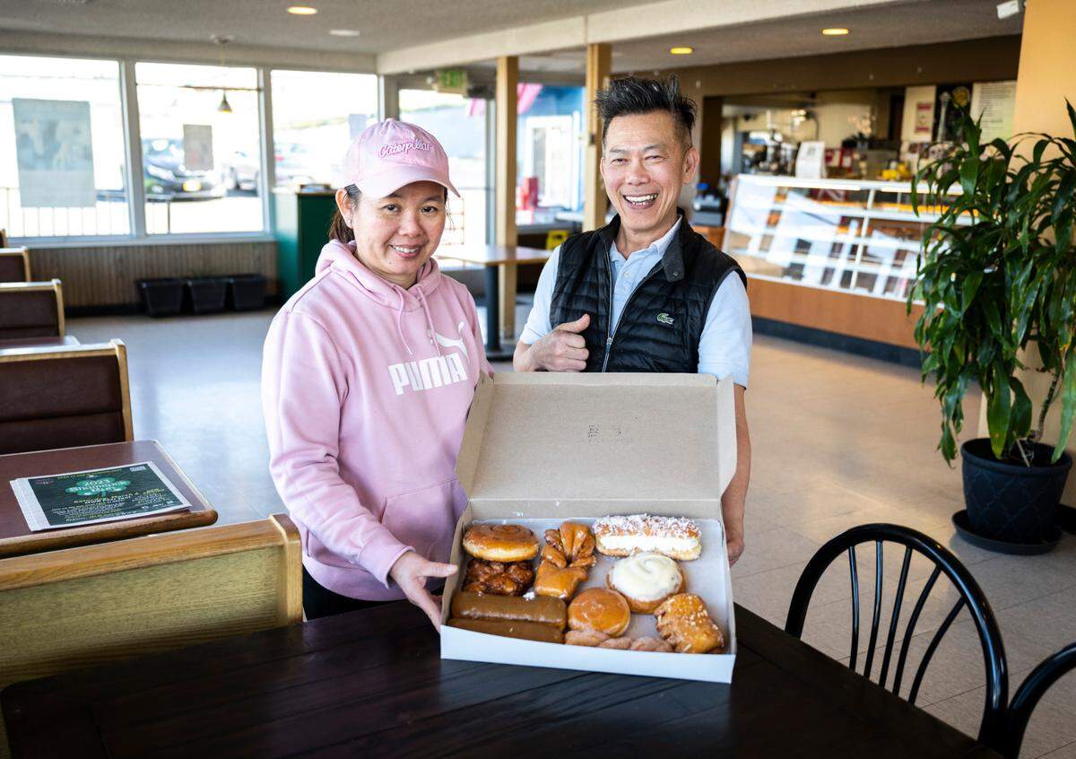 Sam Yam and Kay Oeng pose for a portrait at their shop on Feb. 24, 2023. Dockside Donuts opened in 2010 at 1112 Puyallup Ave. in Tacoma, Wash., but Yam has been making doughnuts since 1985.