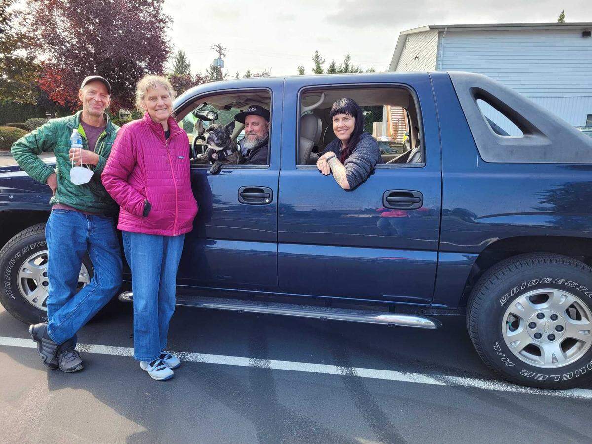 Jeff Perez, Pat Zylius, Bogey the French Bulldog, Ian Cuthbertson and Nicole Cuthbertson headed to the Puyallup Nazarene Church parking lot early Saturday, which was set up as a shelter for families who had to evacuate a 1.1 mile radius of the city due to a large fire.