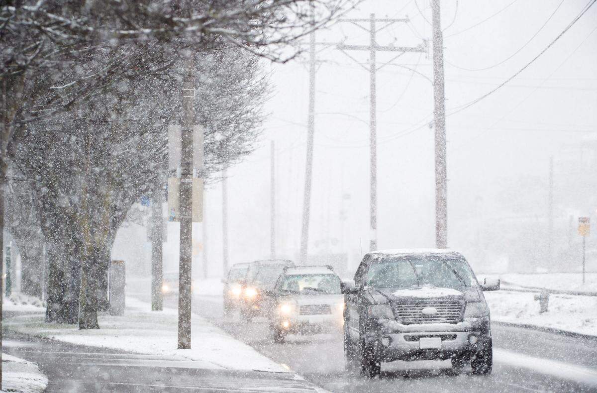 Cars drive along the waterfront near Ruston Way in Tacoma, Wash., on Friday, Feb. 8, 2019.