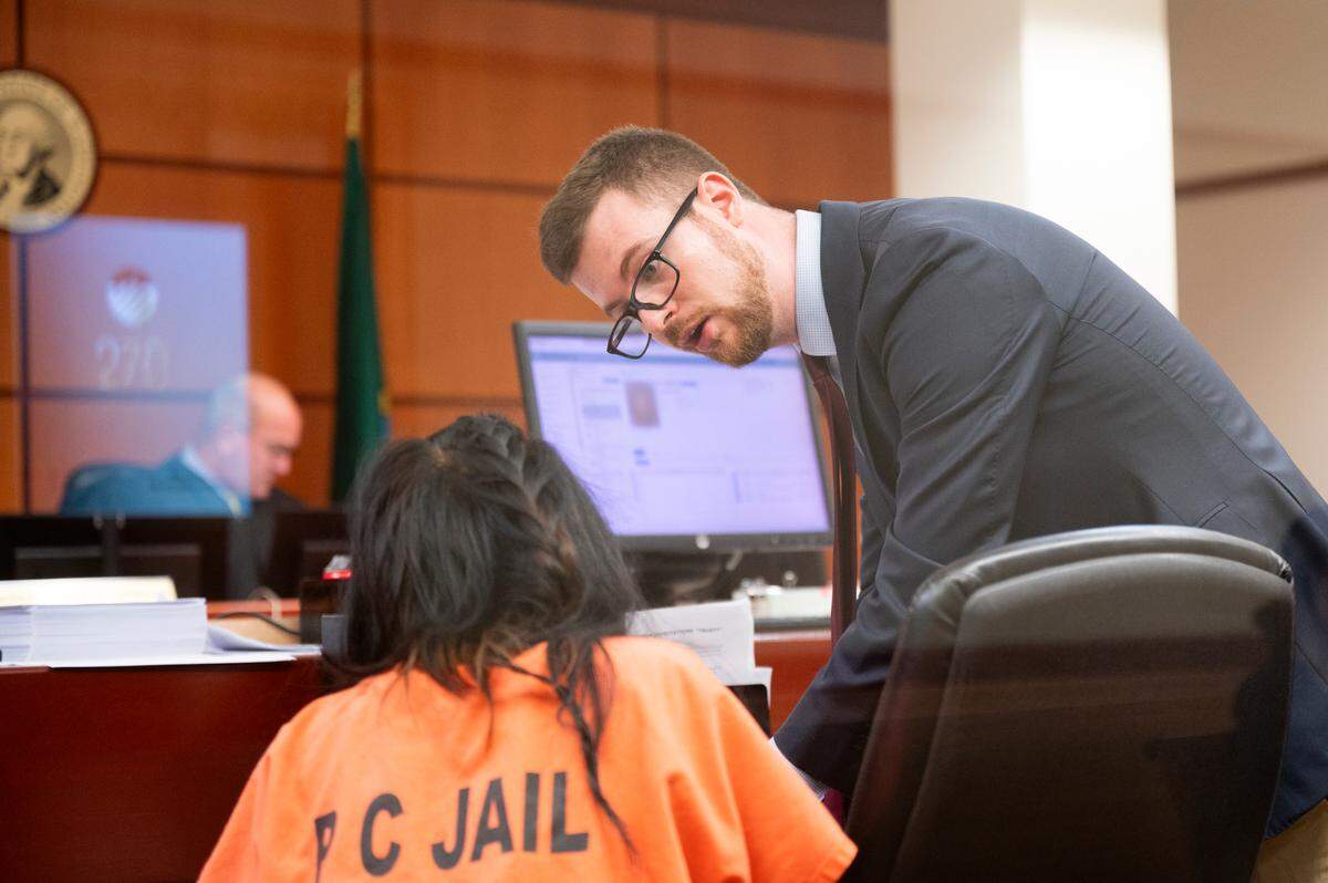 Attorney Nick Ainslie of the Department of Assigned Counsel speaks with a client at Pierce County Superior Court, on Monday, Aug. 5, 2024, in Tacoma.
