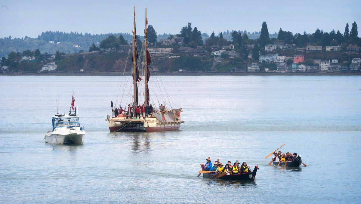 Puyallup Tribe canoes escort the Polynesian voyaging canoe, Hokule’a, upon its arrival at the Thea Ross Waterway in Tacoma, Washington, on Wednesday, Aug. 30, 2023. The canoe and its crew are part of a four-year circumnavigation of the Pacific Ocean that began June 15 in Juneau, Alaska.