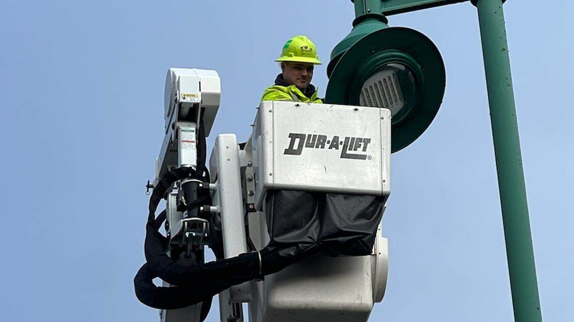 A member of the city of Gig Harbor’s operations staff removes an LED lamp from a city streetlight Jan. 25, 2024.