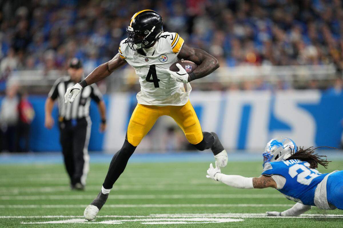 DETROIT, MICHIGAN - DECEMBER 21: Dan Jackson #28 of the Detroit Lions misses a tackle on DK Metcalf #4 of the Pittsburgh Steelers during the fourth quarter at Ford Field on December 21, 2025 in Detroit, Michigan. (Photo by Nic Antaya/Getty Images)