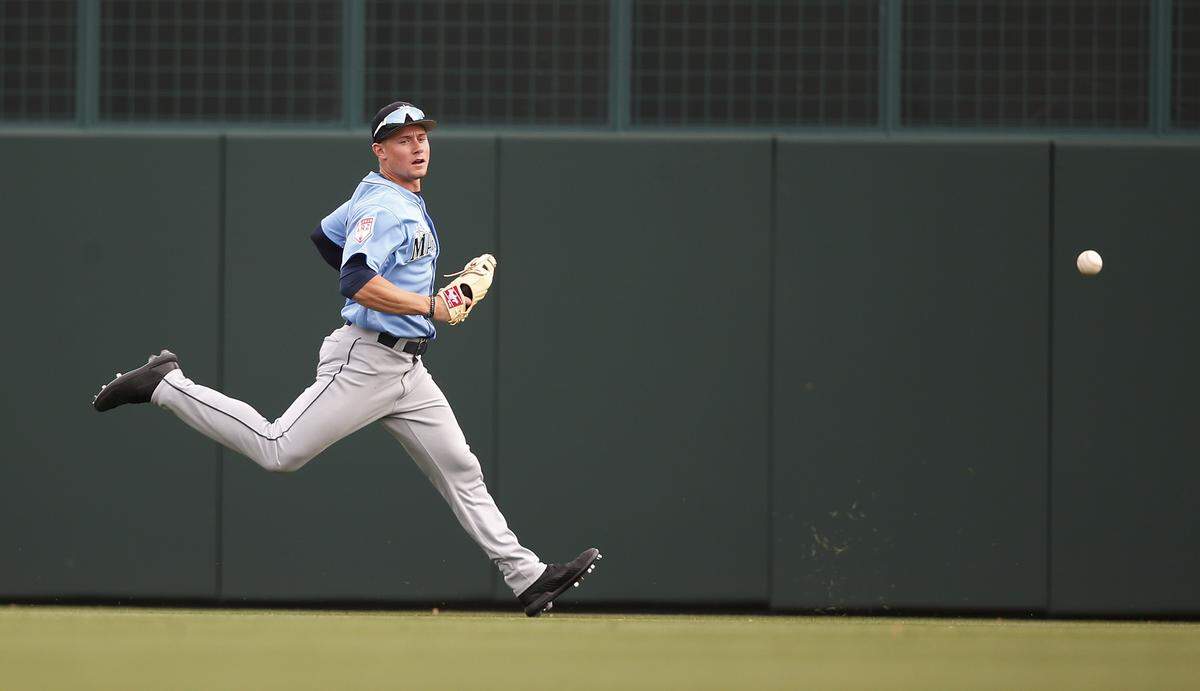 Seattle Mariners’s Jarred Kelenic chases a ball hit by hit by Los Angeles Dodgers’ Keibert Ruiz in the eighth inning of a spring training baseball game Saturday, March 9, 2019, in Phoenix. (AP Photo/Sue Ogrocki)