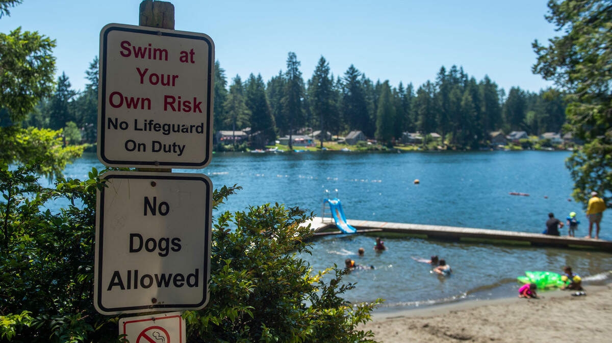 Prominent signage warns visitors to be safe at Lowell Johnson Park, aka “The Ol’ Swimmin’ Hole,” on Anderson Island’s Lake Florence. Photo taken July 2, 2021.