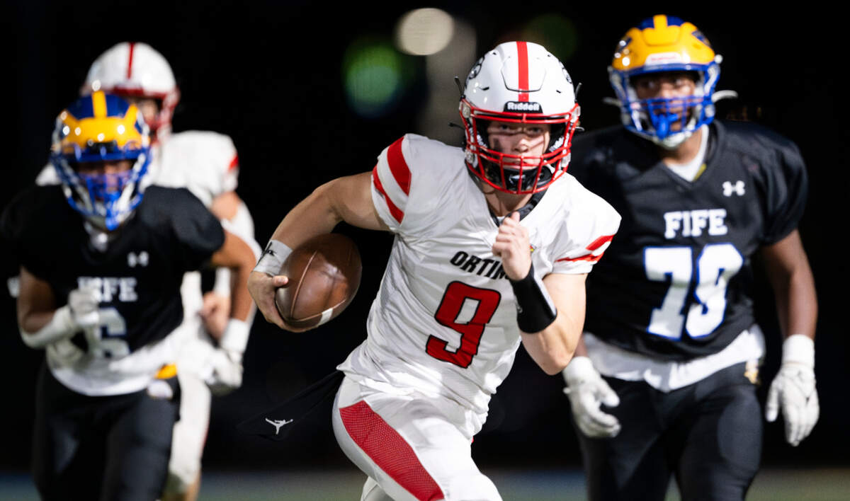 Orting quarterback Zach Gemar (9) keeps the ball during the first half of the game against Fife at Fife High School, on Friday, Sept. 20, 2024, in Fife, Wash.