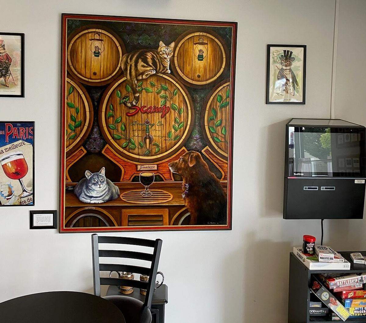 With brother Paulie and fellow pet dog, Scamp the cat sits atop a barrel in a family portrait hanging on the wall of Scamp Brewing in Auburn, Wash.