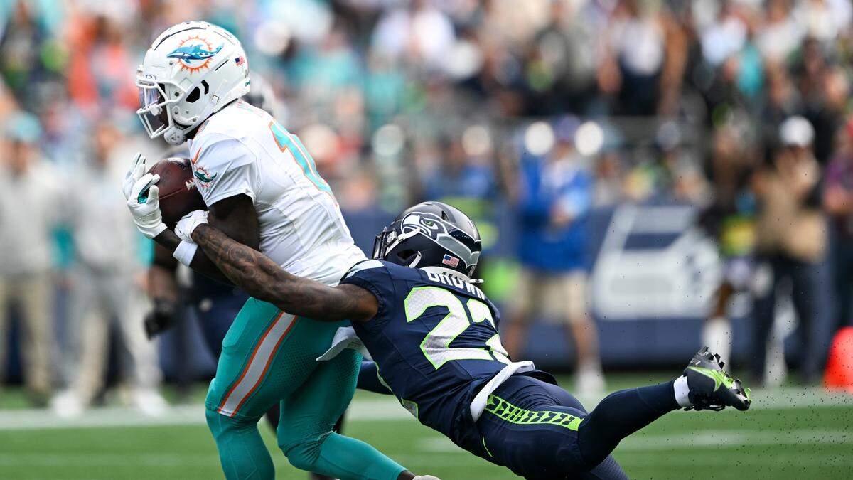 Miami Dolphins wide receiver Tyreek Hill (10) is tackled by Seattle Seahawks cornerback Tre Brown (22) during the third quarter of the game at Lumen Field, on Sunday, Sept. 22, 2024, in Seattle, Wash.