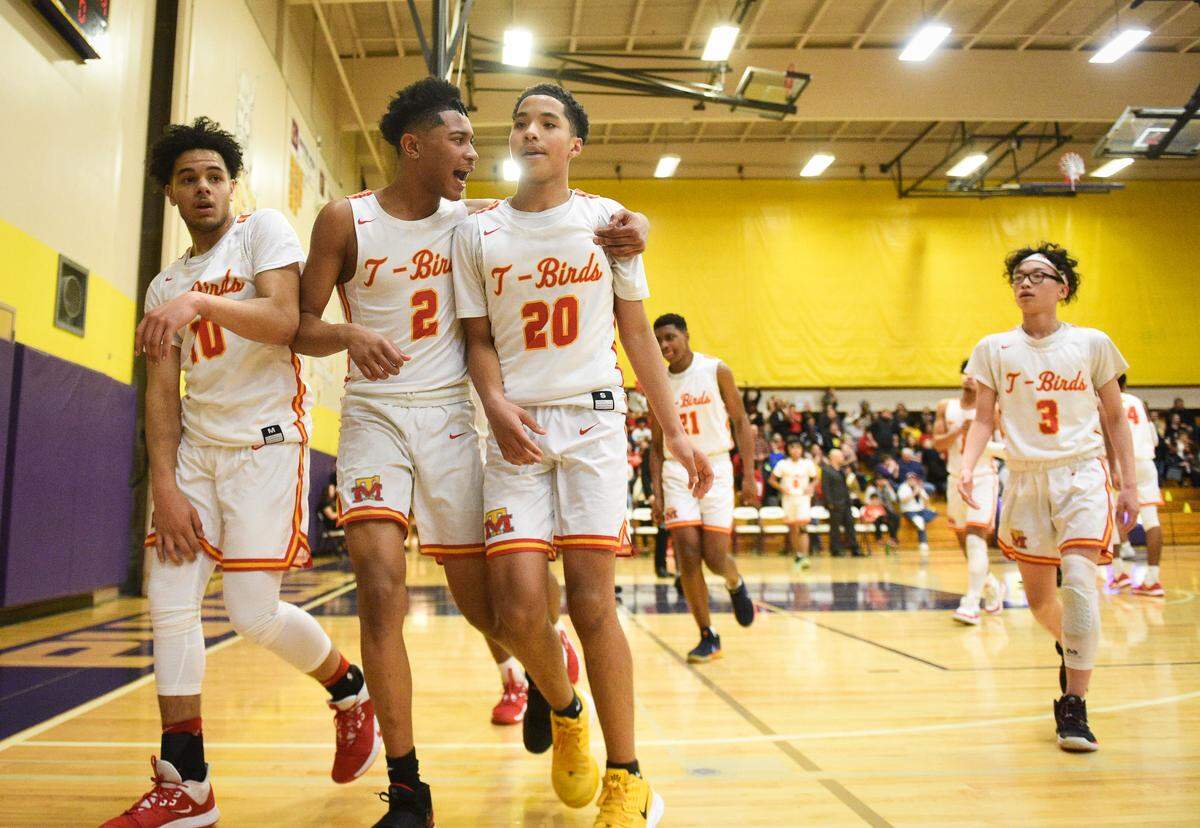Mount Tahoma’s Eloheim Johnson celebrates a three-point-buzzer-beater by Asjon Anderson (20) during the second quarter. Mount Tahoma played Evergreen in a basketball game at Puyallup High School in Puyallup, Wash., on Thursday, Feb. 20, 2020.