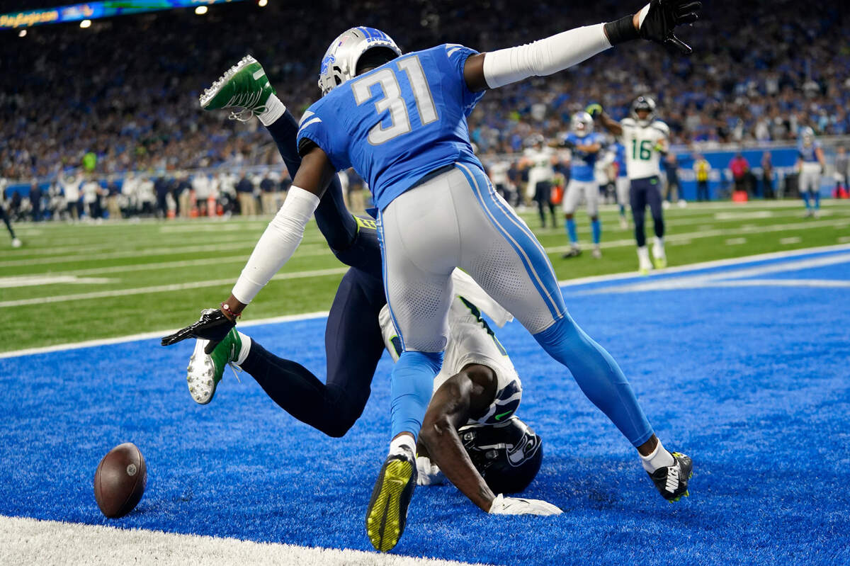 Detroit Lions safety Kerby Joseph (31) breaks up a pass intended for Seattle Seahawks wide receiver DK Metcalf during the second half of an NFL football game, Sunday, Sept. 17, 2023, in Detroit. (AP Photo/Paul Sancya)
