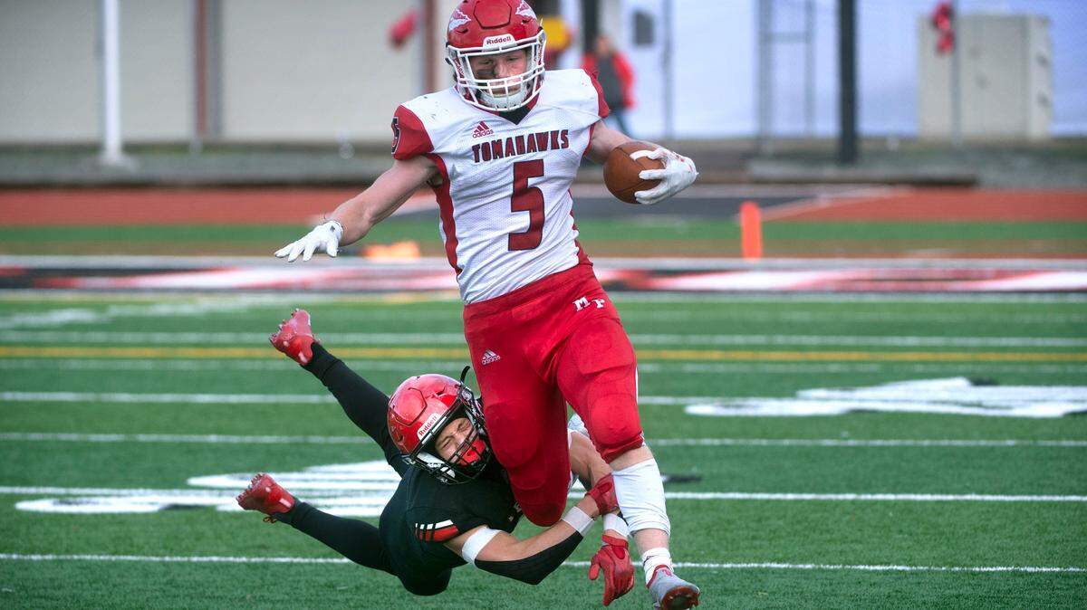 Yelm defensive back Kyler Ronquillo tries in vain to wrap up Marysville-Pilchuck running back Dylan Carson during Saturday afternoon’s 3A football state quarterfinal game at Yelm High School in Yelm, Washington, on Nov. 20, 2021. Marysville-Pilchuck won the game, 39-21.