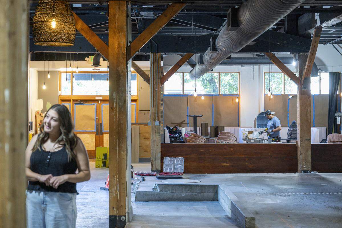 Work takes place on the future playscape, front, and cafe space, back, at Sunrise Play Cafe on Wednesday, Sept. 24, 2025, in Tacoma, Wash.