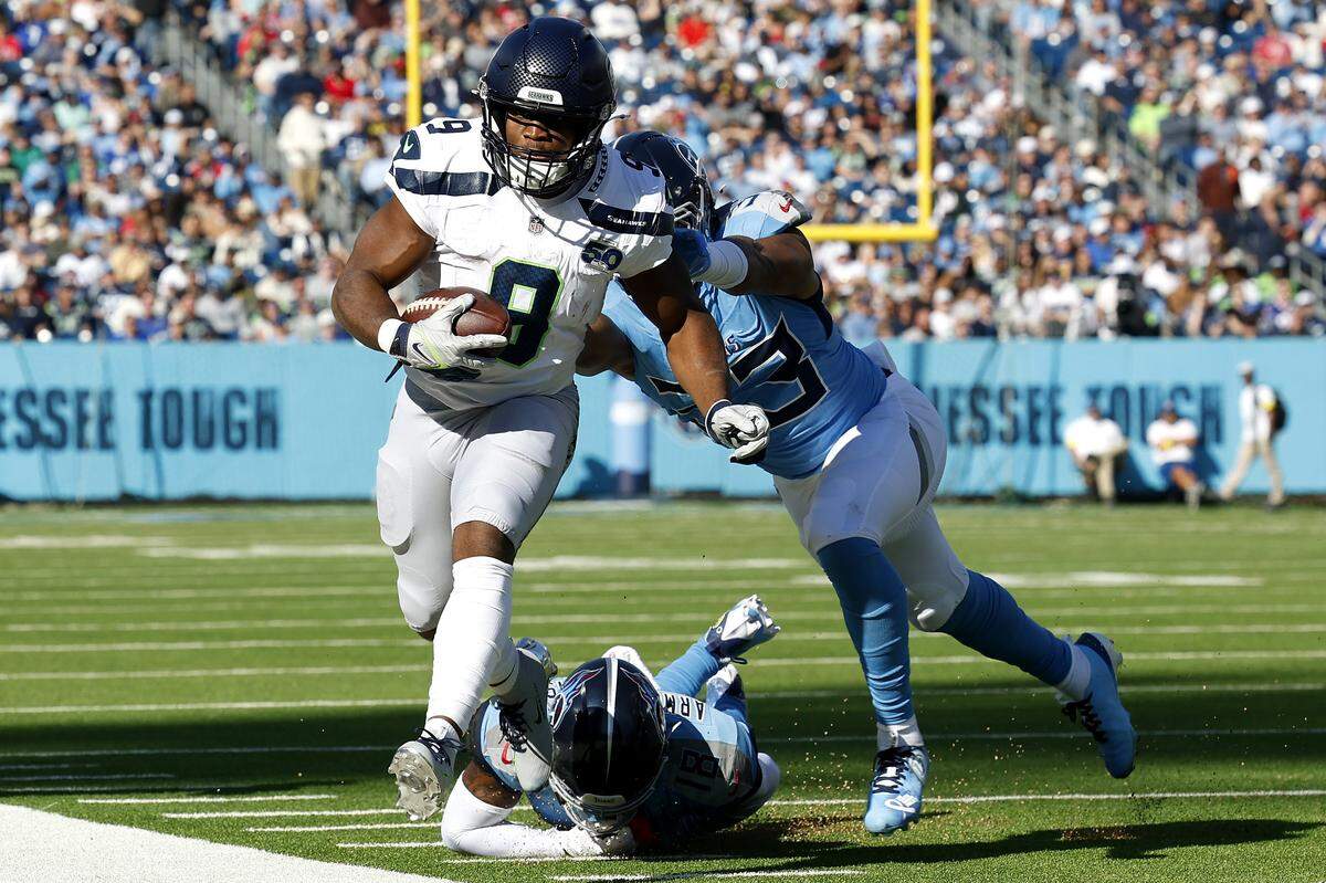 NASHVILLE, TENNESSEE - NOVEMBER 23: Kenneth Walker III #9 of the Seattle Seahawks is pushed out of bounds by Cedric Gray #33 of the Tennessee Titans in the first half of the game at Nissan Stadium on November 23, 2025 in Nashville, Tennessee. (Photo by Wesley Hitt/Getty Images)