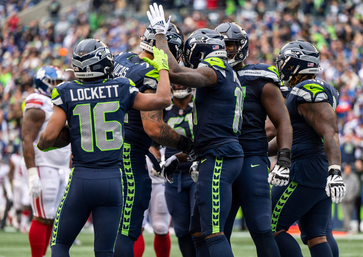 Seattle Seahawks wide receiver DK Metcalf (14) celebrates with his teammates after scoring a touchdown in the second quarter of an NFL game against the New York Giants at Lumen Field in Seattle, Wash. on Oct. 30, 2022.