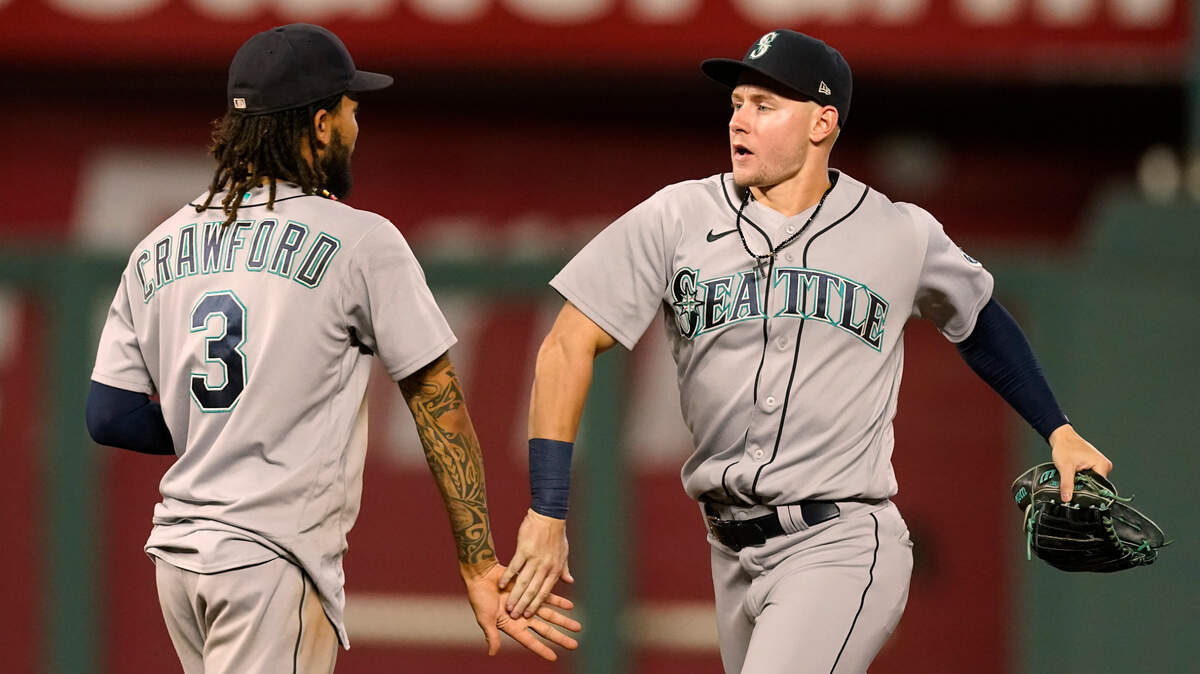 Seattle Mariners’ Jarred Kelenic, right, celebrates with J.P. Crawford (3) after their baseball game against the Kansas City Royals Friday, Sept. 17, 2021, in Kansas City, Mo. Seattle won 6-2. (AP Photo/Charlie Riedel)