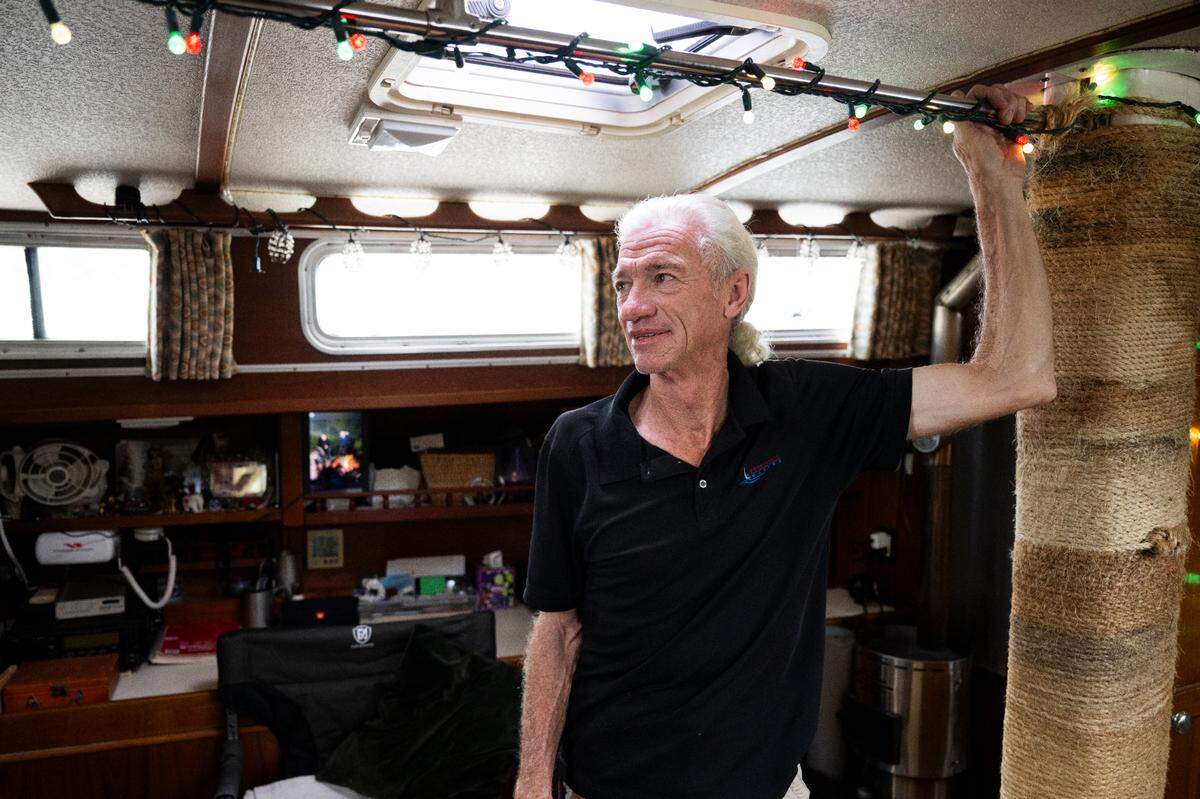 Scott Monett lives in his sailboat with his partner Kelly Mills and two cats, Tigger and Luna, at the Foss Harbor Marina. Photographed on Monday, Sept. 23, 2024, in Tacoma.