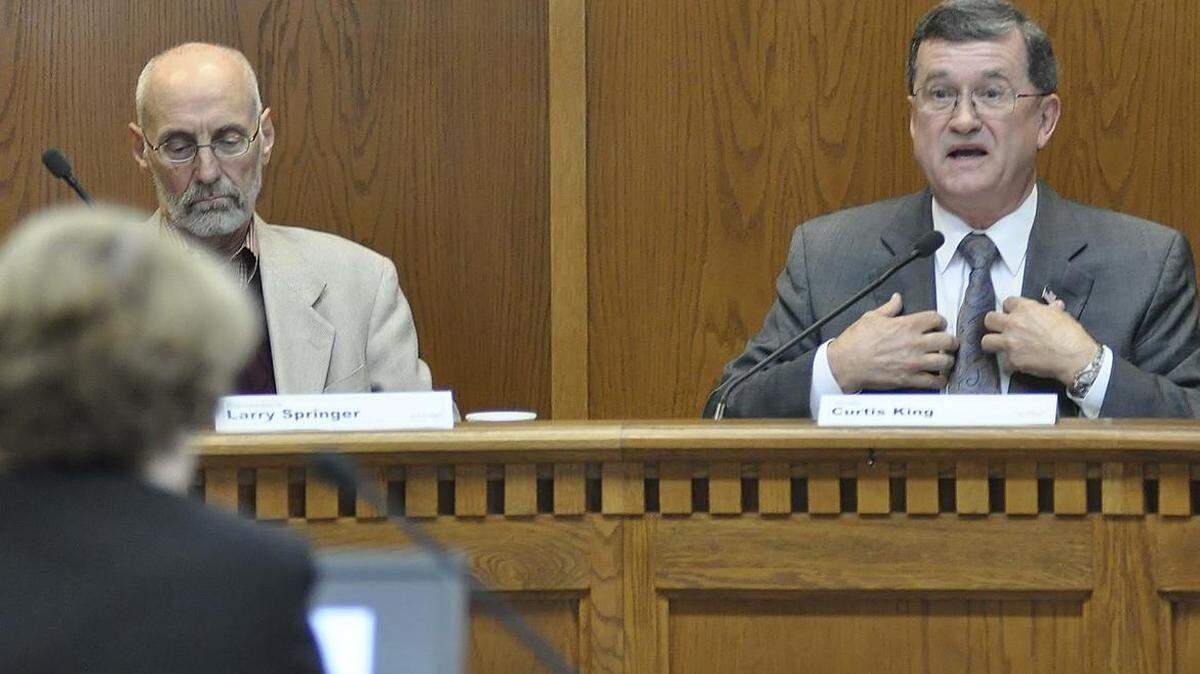Sen. Curtis King, right, co-chairman of the Legislative Task Force on Public Records, tells media attorney Kathy George that lawmakers should be able to keep some of their records from the public just as newspapers sometimes use anonymous sources. King, R-Yakima, is flanked by Rep. Larry Springer, D-Kirkland, the group’s other co-chairman, at a meeting Tuesday.