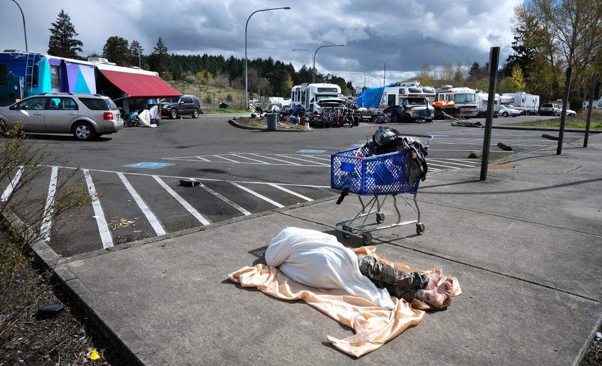 Motorhome and travel trailers are seen in the Pierce Transit Center Street park-and-ride lot on bordering state Route 16 in Tacoma on Wednesday, April 19, 2023.