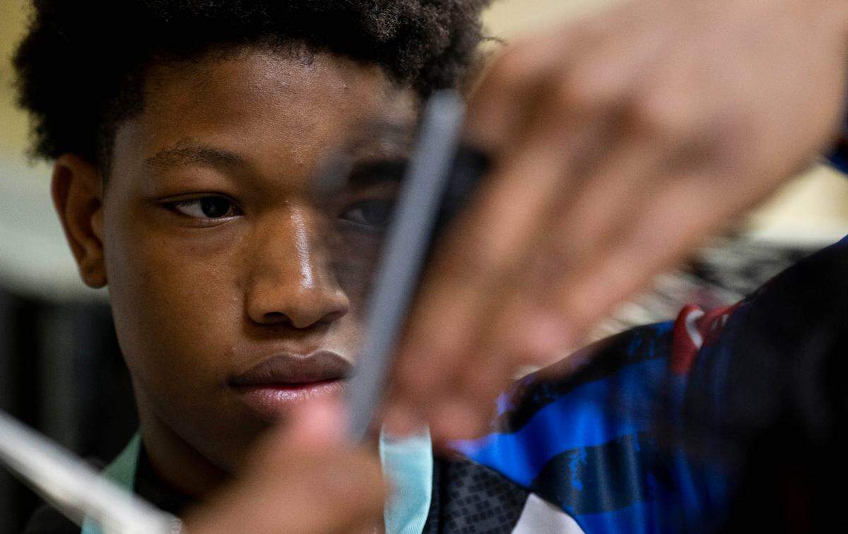 Josh Larkins, 17, learns how to do a 90-degree cut from instructor Sheron Rogers at Bates Barber Shop, part of the Bates Technical College barber program, on Tuesday, April 23, 2024, in Tacoma, Wash.