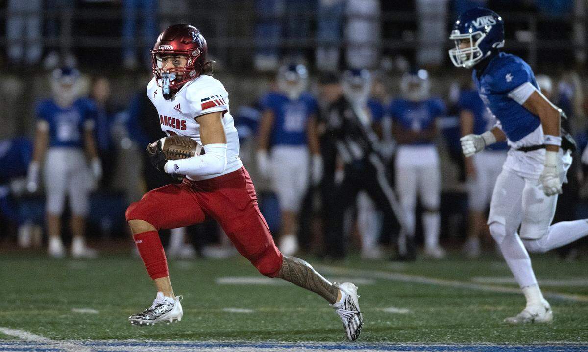 Kennedy Catholic quarterback Devon Forehand breaks away from Curtis defender Xavier Ahrens for a touchdown run during Friday night’s 4A state football opening round game at Viking Stadium in University Place, Washington, on Nov. 10, 2023. Kennedy Catholic won the game, 37-34.