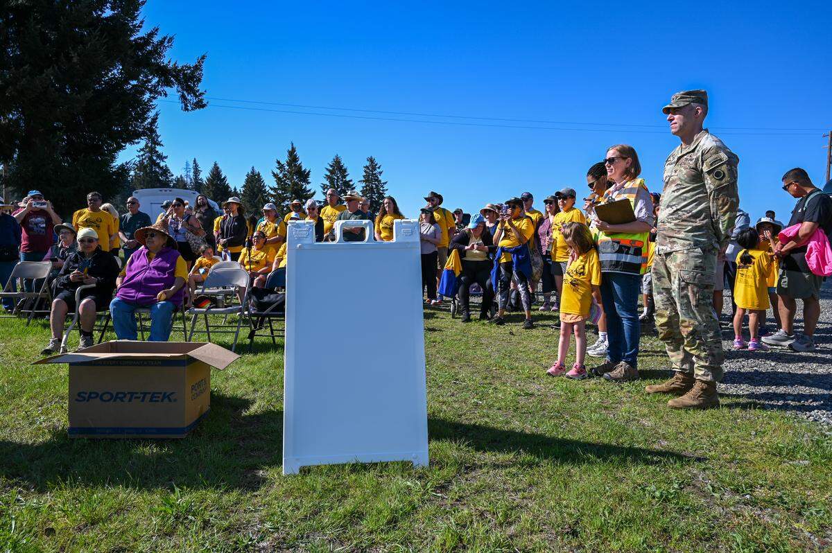 Members of the Nisqually community and Col. Joe Henke listen to Hanford McCloud open the ceremony.