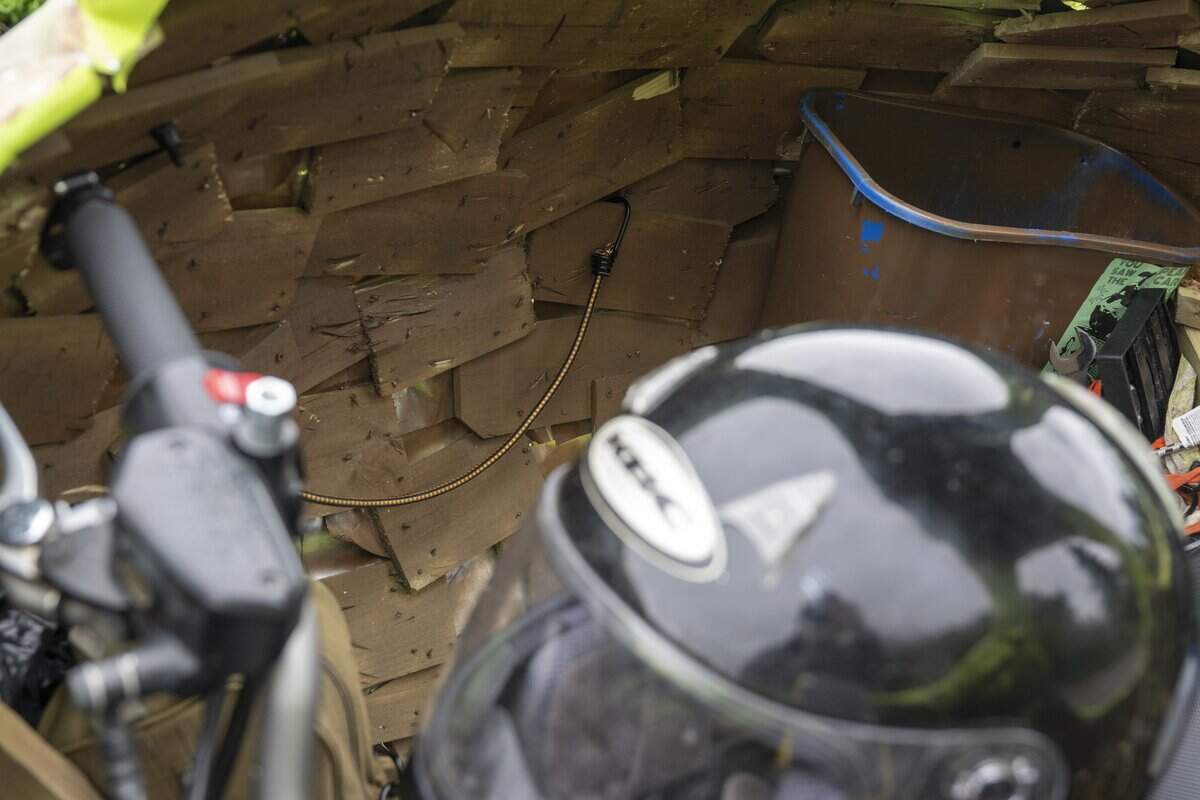 Cut up strips of fence wood are screwed together to form the Pear Car around the frame of a motorcycle on Wednesday, July 8, 2026, in Tacoma, Wash.