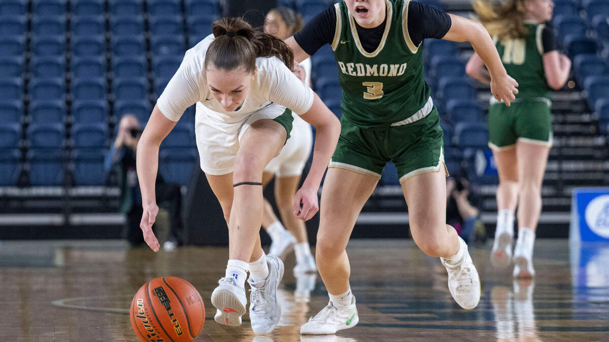 Auburn’s Avery Hansen (3) picks up a loose ball away from Redmond guard Yuki Willis (3) during the second half of a Class 4A state basketball tournament first-round game at the Tacoma Dome on Wednesday, March 5, 2025, in Tacoma, Wash.