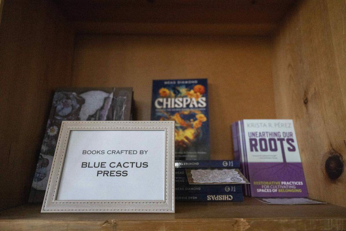 Books published by Blue Cactus Press sit on a bookshelf in the publisher's studio space on Thursday, Feb. 26, 2026, in Tacoma, Wash.