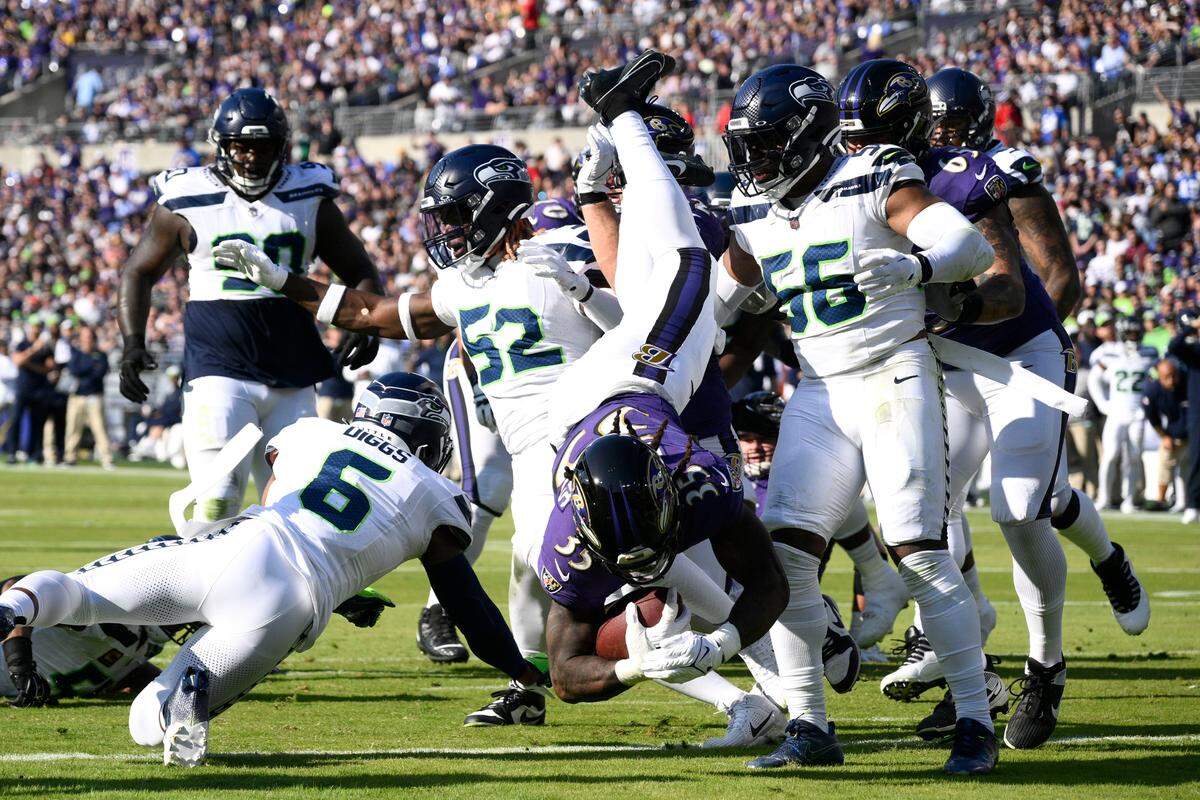 Baltimore Ravens running back Gus Edwards (35) scores on a 4-yard touchdown run during the first half of an NFL football game against the Seattle Seahawks, Sunday, Nov. 5, 2023, in Baltimore. (AP Photo/Nick Wass)