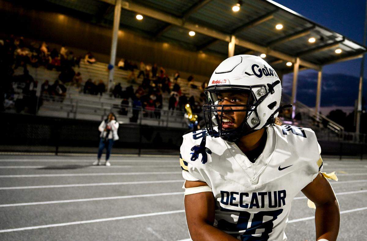 Decatur’s Nehemiah Washington (28) celebrates a touchdown on the sidelines during the first half of the game against the Federal Way Eagles at Federal Way Memorial Stadium, Thursday, Oct. 26, 2023, in Federal Way, Wash.