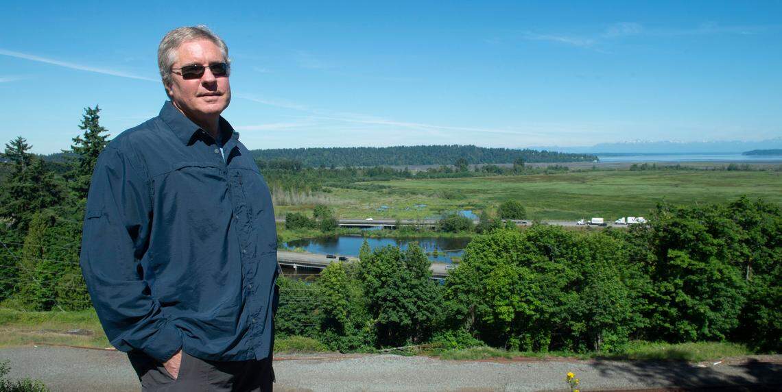 Bill Adamson, a manager at the military lobbying group South Sound Military and Communities Partnership, stands at a viewpoint where Interstate 5 crosses the Nisqually River delta. Adamson is worried about the potential impacts flooding could have on the economy and Joint Base Lewis-McChord, nine miles north of the bridge. “I-5 is the lifeline of commerce for this South Sound region,” Adamson said.