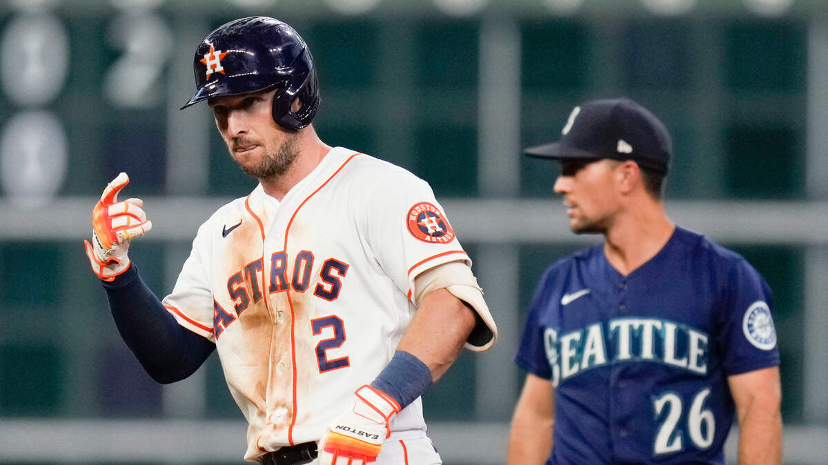 Houston Astros’ Alex Bregman, left, reacts after hitting a double during the sixth inning of a baseball game against the Seattle Mariners, Saturday, July 30, 2022, in Houston. (AP Photo/Eric Christian Smith)