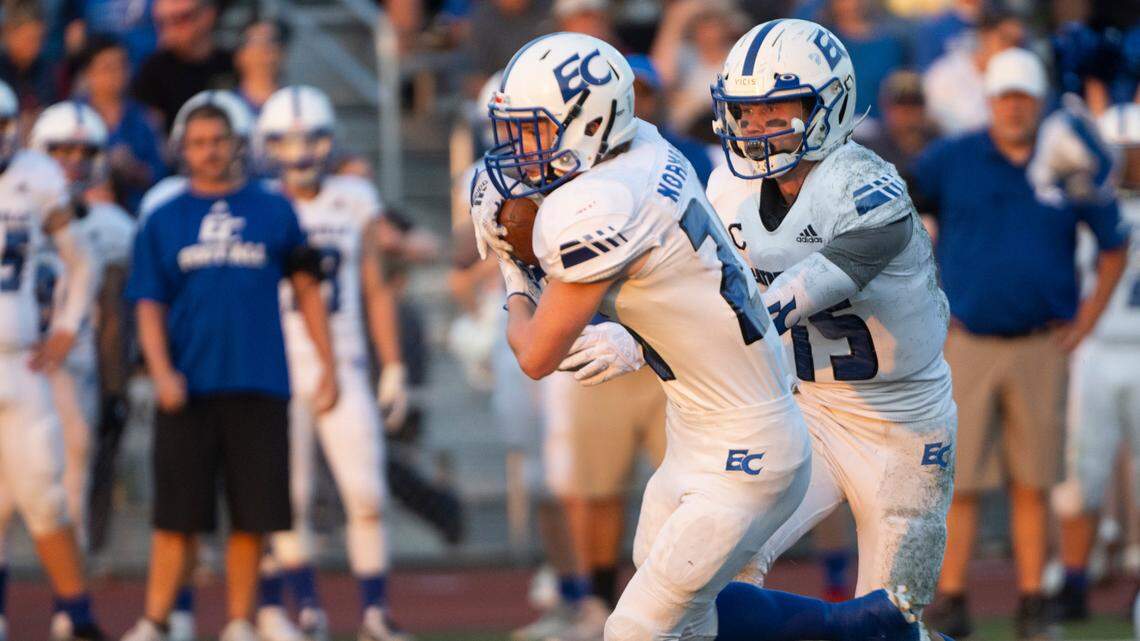 Eatonville quarterback Job Kralik (15) hands the ball off to Eatonville running back Dylan Norman (26) during the first quarter of a Friday night game at Orting Stadium in Orting, Wash. on Sept. 9, 2022.