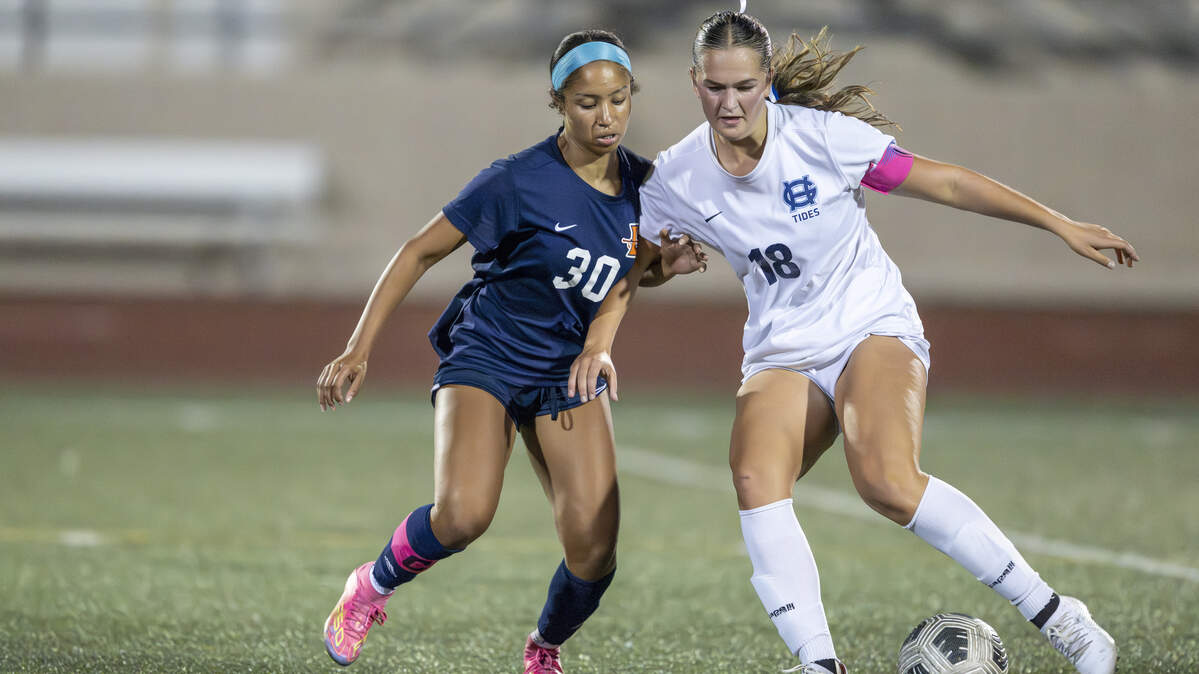 Lakes senior Braelyn Carey (30) pressures Gig Harbor senior Sage Sturrock (18) for control of the ball during a game on Tuesday, Sept. 16, 2025, in Lakewood, Wash.