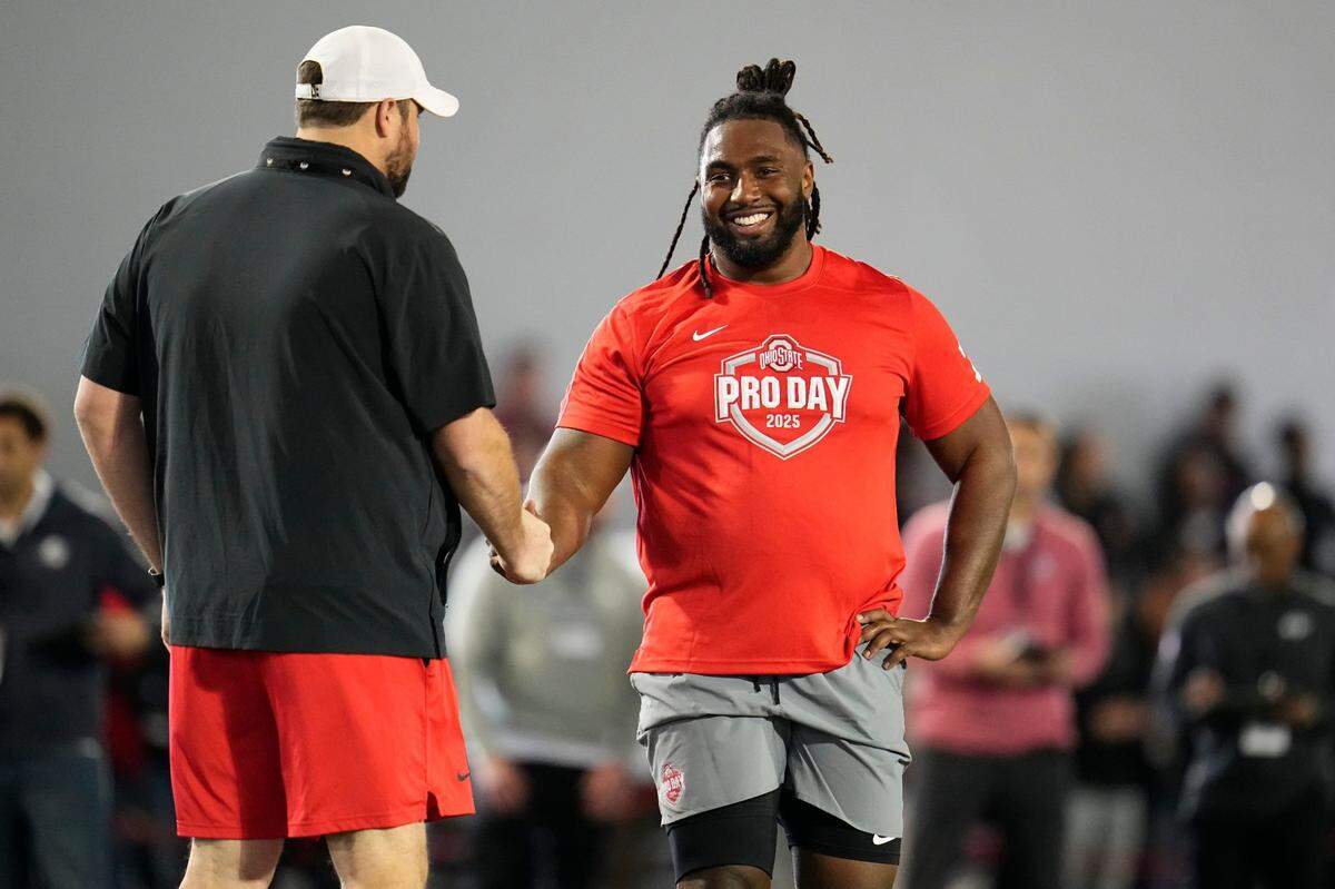 Ohio State Buckeyes offensive lineman Donovan Jackson (74) gets a high five from current Ohio State offensive line coach yler Bowen during the pro day for NFL scouts at the Woody Hayes Athletic Cente on March 26, 2025.