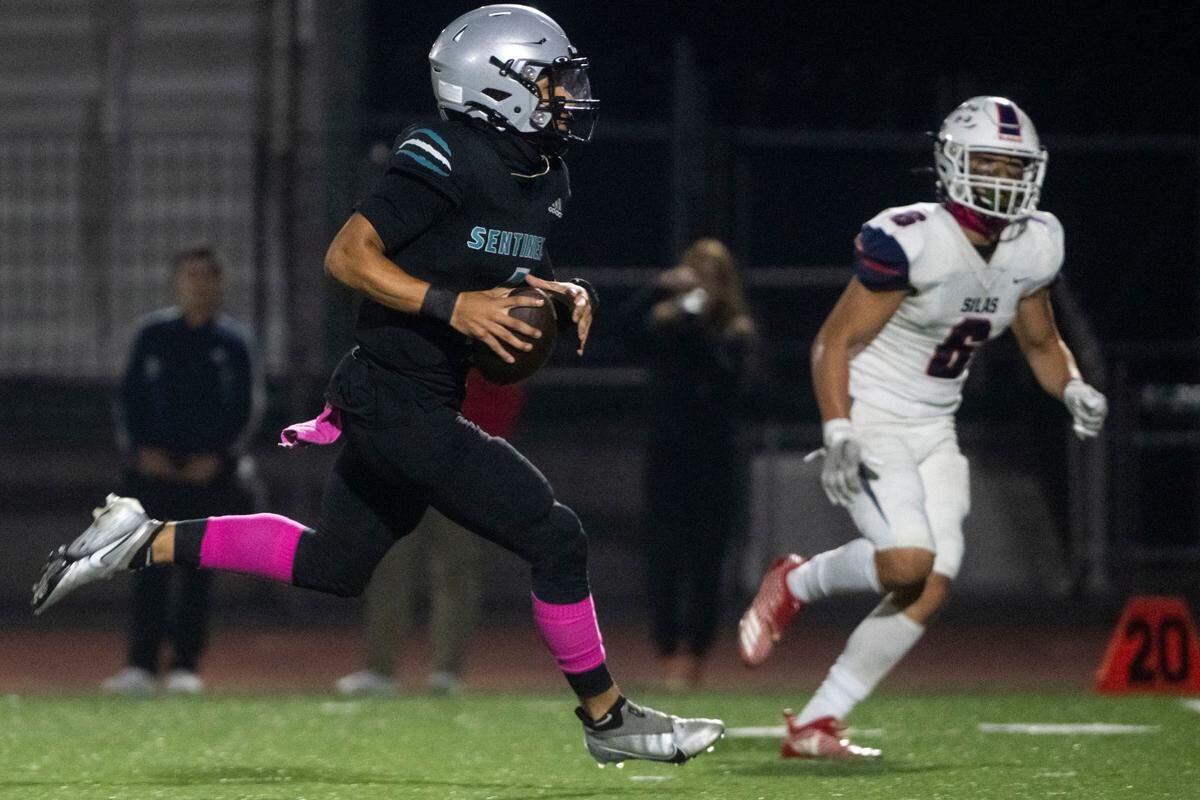 Spanaway Lake quarterback Dempsy James scrambles for a touchdown during the first quarter of a 3A PCL game against Silas on Friday, Oct. 7, 2022, at Art Crate Field in Spanaway, Wash.