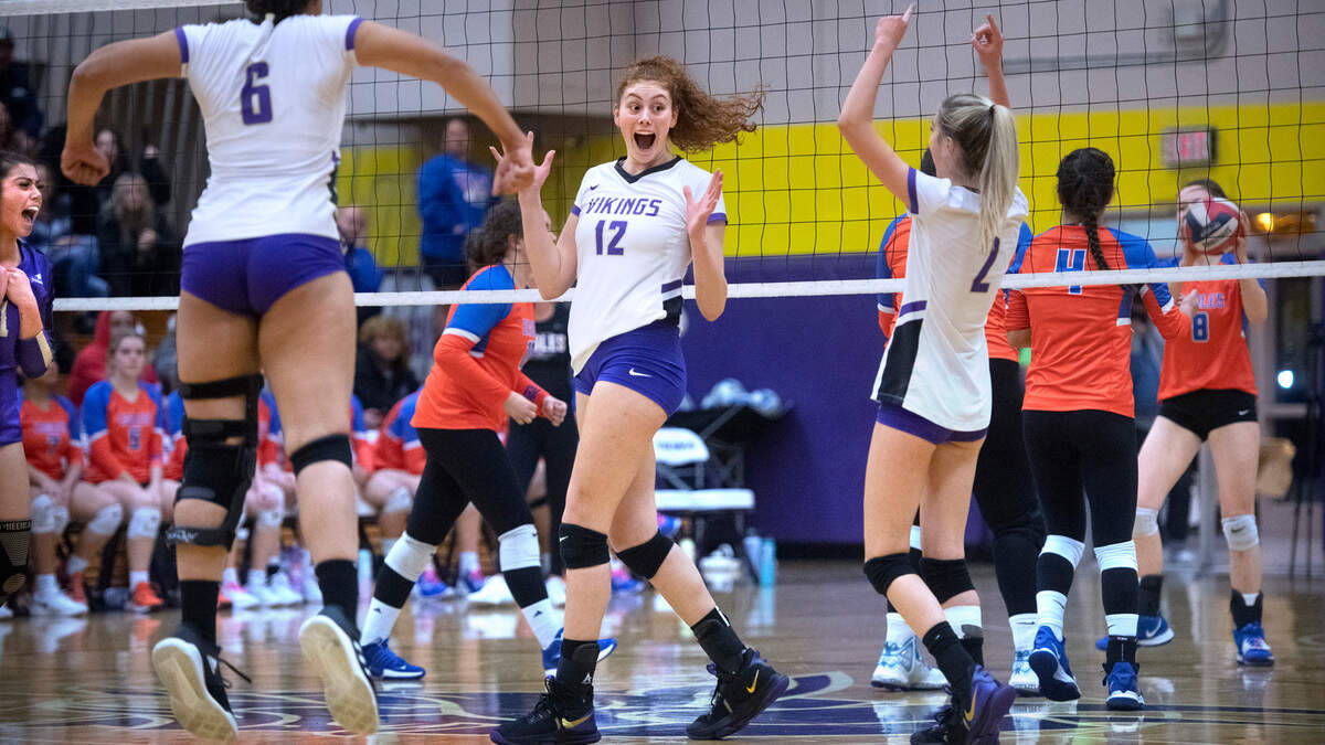 Puyallup’s Krista Sugai (9), Dani Brown and Reese Sheppard celebrate a point win against Graham-Kapowsin during their regular season finale volleyball match at Puyallup High School in Puyallup, Washington, on Tuesday, Oct. 25, 2022. After dropping the first two games, 22-25 and 21-25, Puyallup rebounded to sweep the final three games, 25-22, 25-19 and 15-13, for the best of five victory.