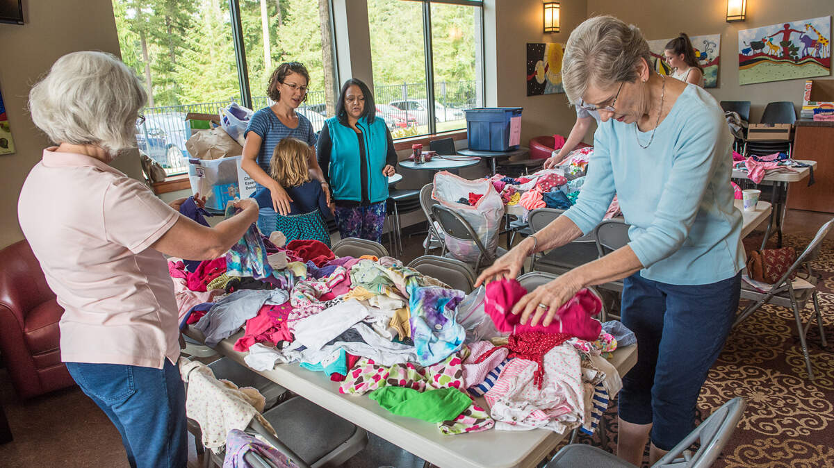 Harbor Covenant Church volunteers help sort clothes at the 9th annual Compassion, Mercy, Justice Sunday.