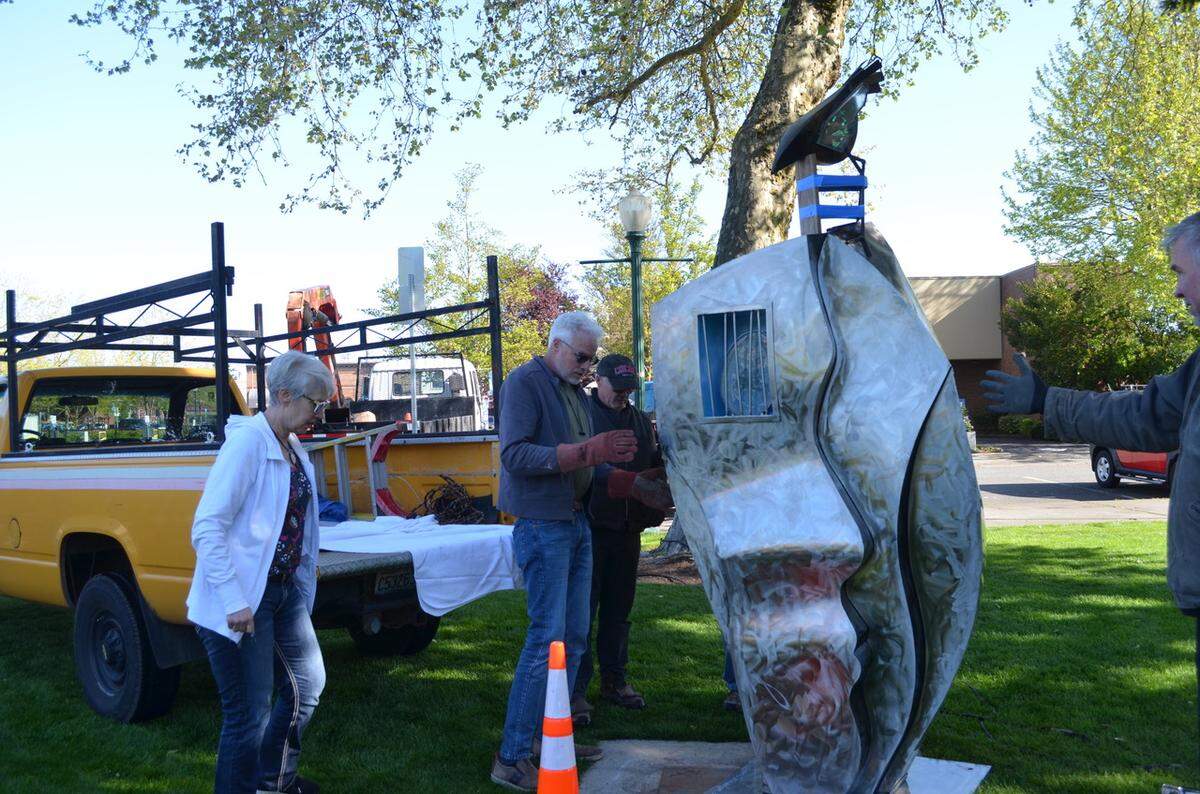 Artist Sharon Warman Agnor watches as her piece, The Choice, is installed in Pioneer Park.