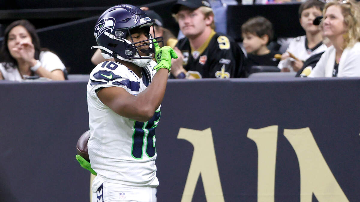 Seattle Seahawks wide receiver Tyler Lockett silences the crowd after catching a touchdown pass from quarterback Geno Smith during an NFL football game against the New Orleans Saints in New Orleans, Sunday, Oct. 9, 2022. (AP Photo/Derick Hingle)