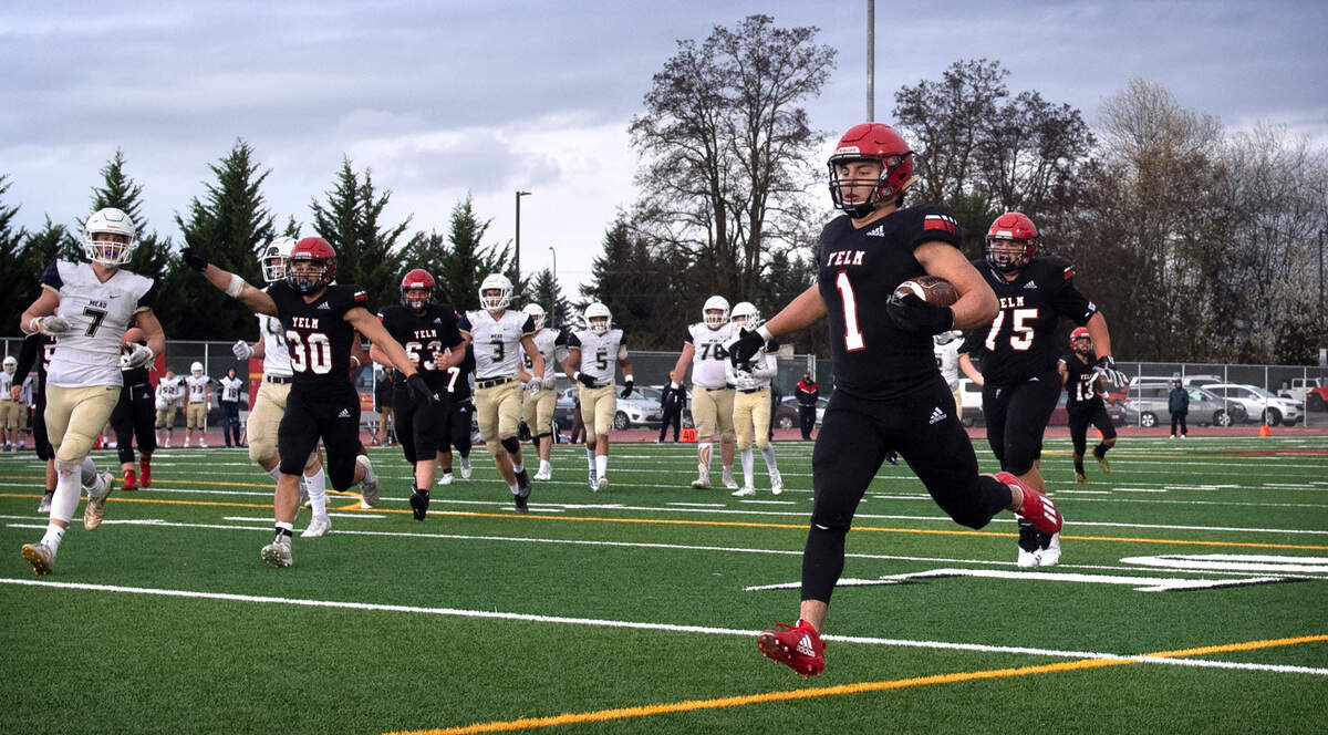 Yelm running back Ray Wright runs untouched into the end zone touchdown on a fake reverse during Saturday afternoon’s high school football playoff game against the Mead Panthers at Yelm High School in Yelm, Washington, on Nov. 6, 2021. Yelm won the game, 37-21.