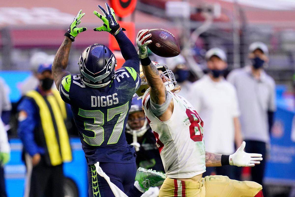 San Francisco 49ers tight end George Kittle (85) makes a catch as Seattle Seahawks free safety Quandre Diggs (37) defends during the second half of an NFL football game, Sunday, Jan. 3, 2021, in Glendale, Ariz. (AP Photo/Ross D. Franklin)